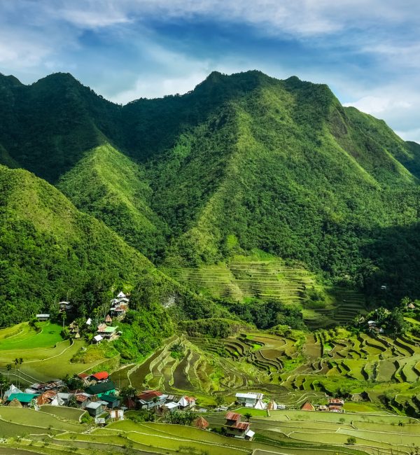Village houses near rice terraces fields. Amazing abstract texture with sky colorful reflection in water. Ifugao province. Banaue, Philippines UNESCO heritage